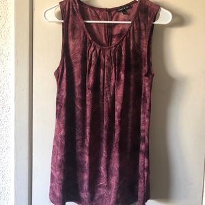 A sleeveless pink blouse